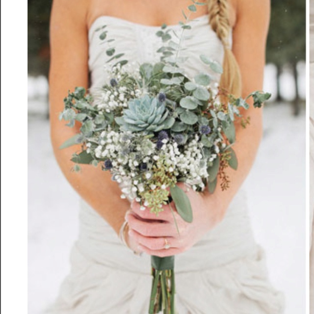 a woman holding a bouquet of flowers in the snow