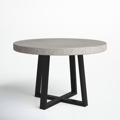 a concrete table with black metal legs on a white background