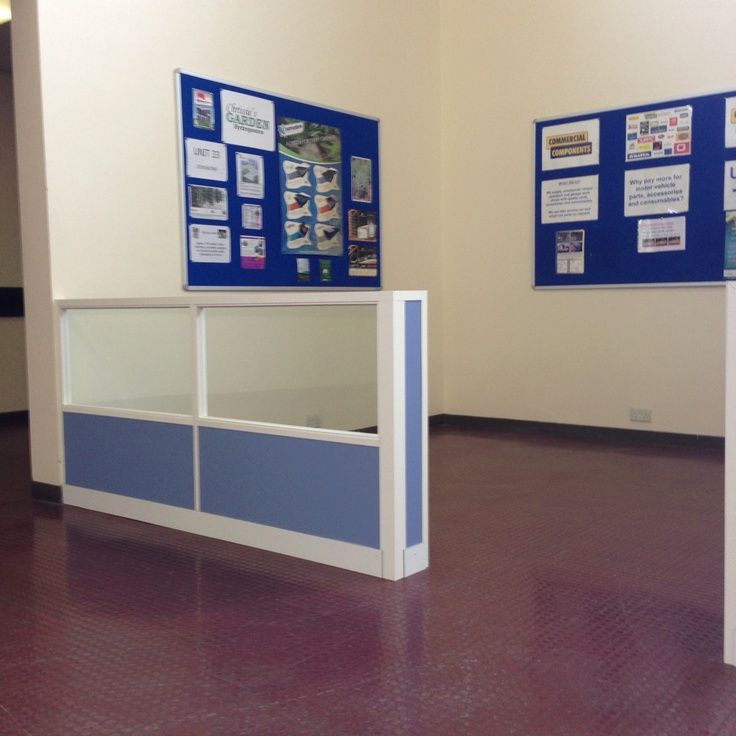 an empty room with two blue and white displays on the wall next to each other