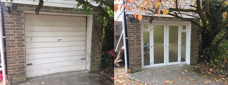 two garages in front of a brick building with white doors and windows on each side