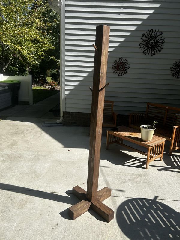 a tall wooden pole sitting in the middle of a patio next to a table and chairs