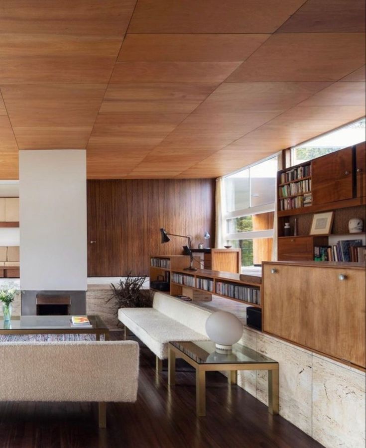 a modern living room with wood paneling and furniture