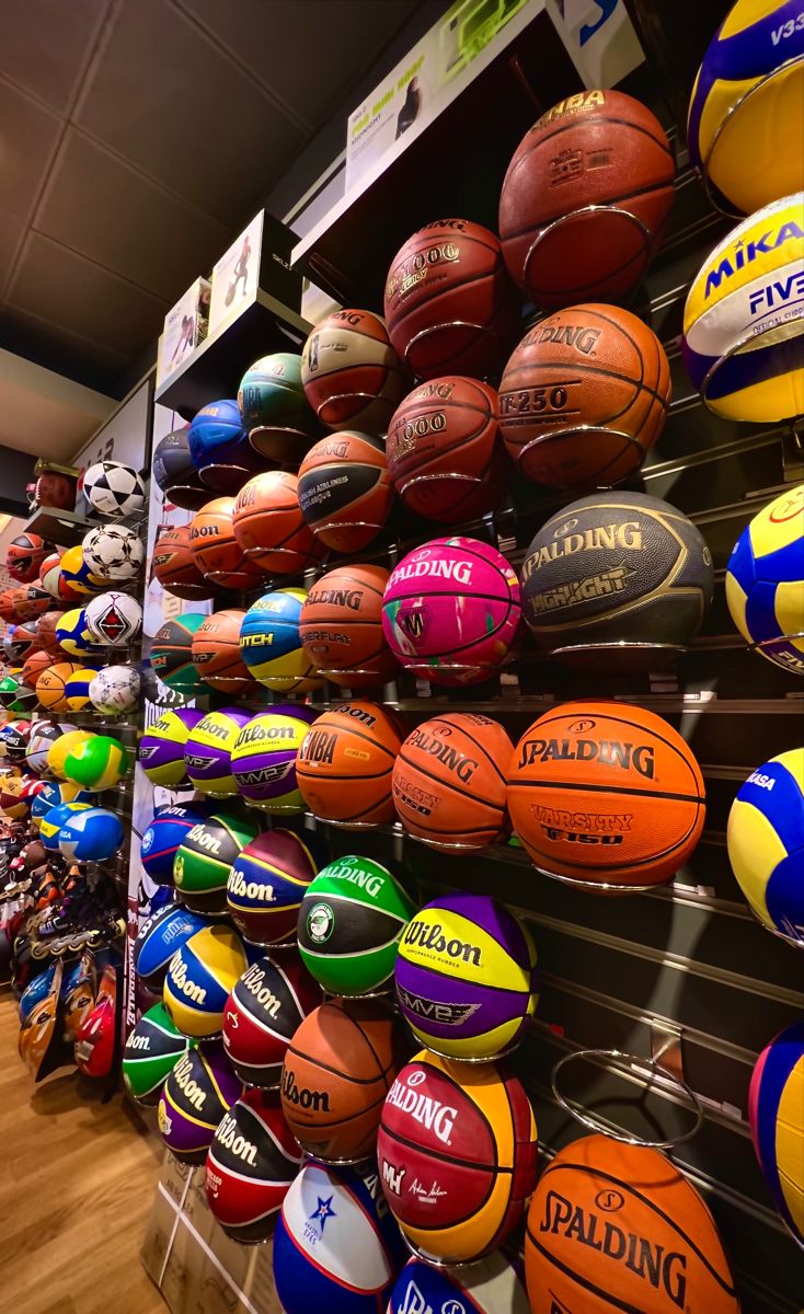 basketballs and other sports balls on display in a store