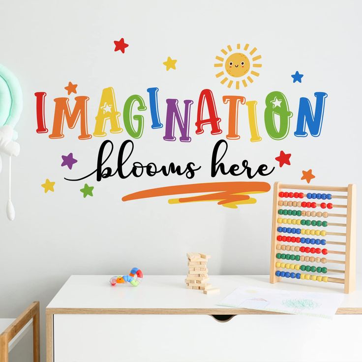 there is a wall decal that says,'imagine nation blooms here'in multicolored letters