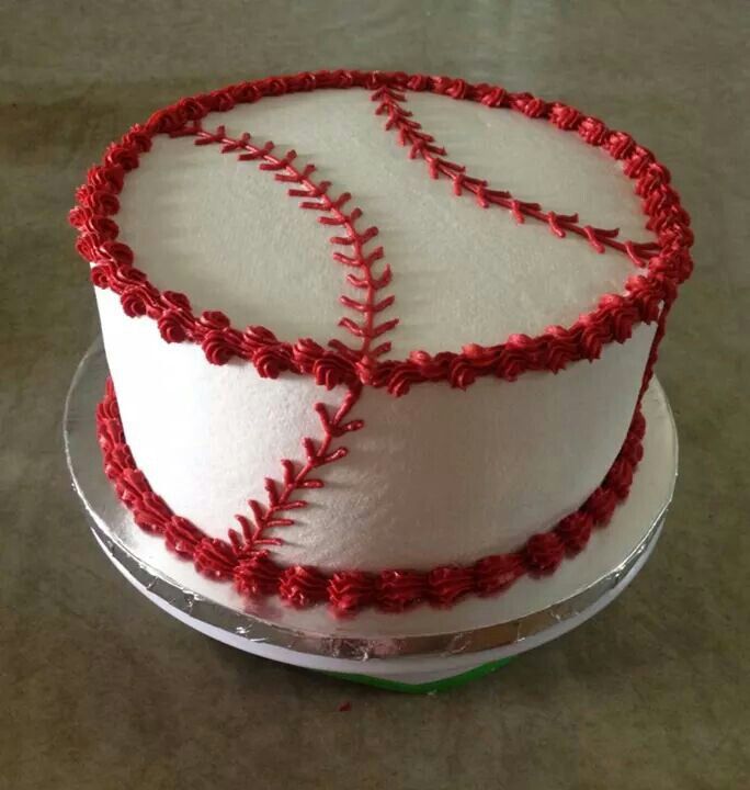 a cake decorated with red thread on top of a table