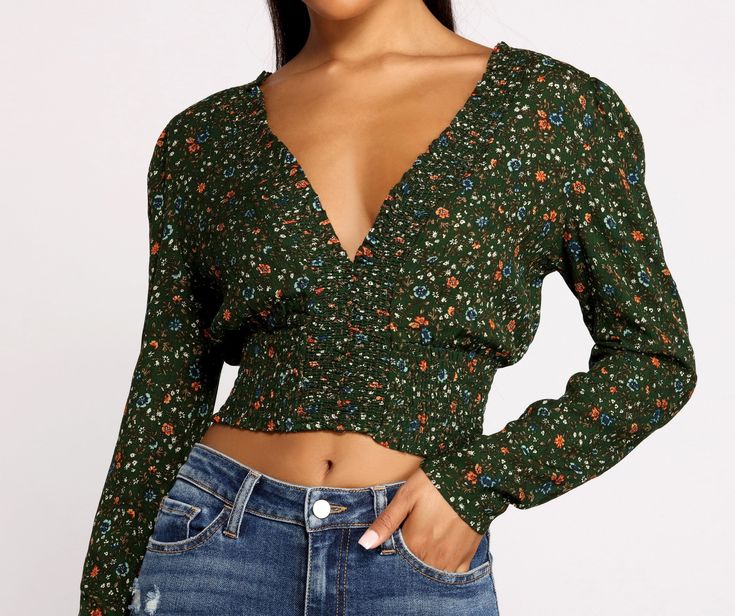 Show off your sweet side in a floral crop top that brings the charm. The crop top features a plunging V-neckline. a partially smocked bodice. and a pretty floral print. Complete your look with high waist jeans and ankle booties.Fit & Features Plunging V-neckline Partially smocked knit bodice Long sleeves Floral print Cropped hem Open back with back ties Form hugging fit. moderate stretch Spring Floral Print V-neck Smocked Top, Floral Print V-neck Smocked Top For Brunch, Trendy V-neck Top With Smocked Back, Spring Flirty V-neck Crop Top, Chic V-neck Floral Print Crop Top, Flirty V-neck Spring Crop Top, Spring Casual Low-cut Tops, Casual Low-cut Tops For Spring, Casual Low-cut Spring Tops