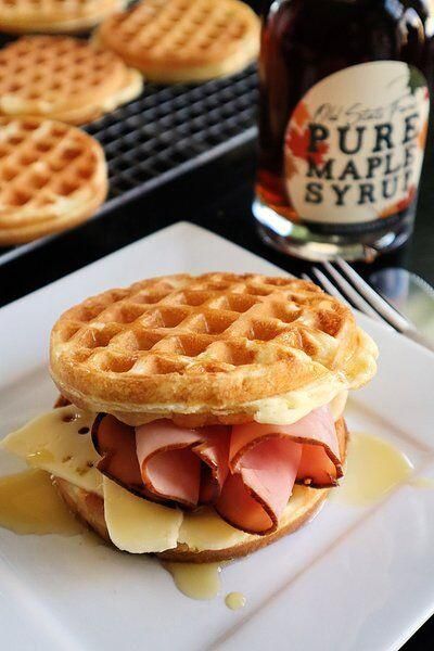 a waffle sandwich on a plate with syrup