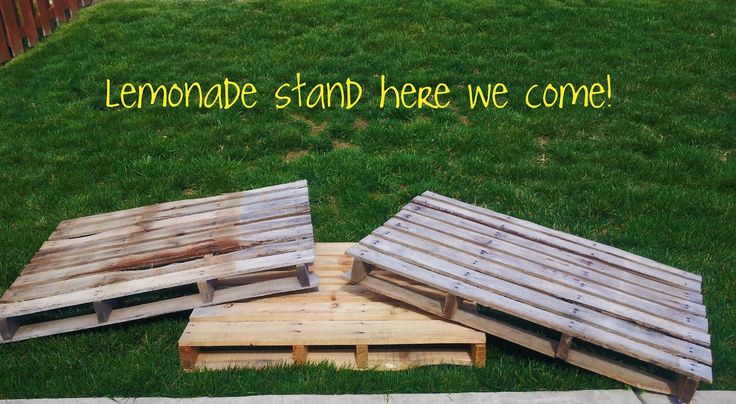 three wooden pallets sitting in the grass