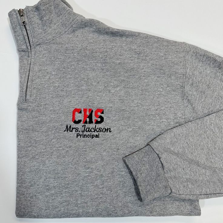 This sweatshirt lets you customize it with your school's initials in two thread colors, and a name below with an additional line of optional text underneath for a title school name, mascot name, etc. The optional line of text with be done in our basic block font due to size constraints. Product Details Adult Unisex Sizes Size Chart In Photos Pre Shrunk 50% Cotton 50% Polyester Pill resistant fleece, ribbed collar, cuffs, and waistband with spandex VIDEO: Katie is wearing a size small in the video and is 5'8, 155lbs for reference. Display Photo Display Photo: Oxford Grey Sweatshirt, Red & Black School Initial Thread, Black Name/Text Thread, Script Name Font Half-zip Sweatshirt For College, Charleston Wv, Block Font, Thread Colors, Photo Display, School Colors, Grey Sweatshirt, Pullover Sweatshirt, Quarter Zip