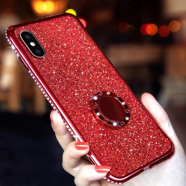 a woman's hand holding an iphone case in red glitter