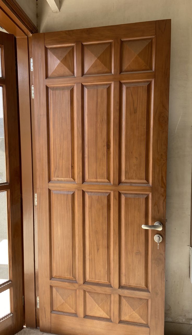 a wooden door in front of a window