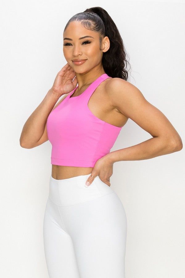 Featuring a high neckline and a strappy open back, this longline sports bra is perfect for any type of workout and you'll be fully supported with style. Best part, the inner lining is all mesh with two removable pads for your comfort. Strappy X back detail High neckline Matte fabric detail Two removable cups with mesh lining Longline hem for comfort and tummy control during workouts Moisture wicking fabric 75% Nylon, 25% Spandex Lining: 80% Nylon, 20% Spandex Imported Model StatsHEIGHT: 5'9" BUS Sporty T-back Halter Top For Sports, Sleeveless Sports Bra For Light Sports With 4-way Stretch, Workout Halter Crop Top With Built-in Bra, Compression Racerback Crop Top For Training, Seamless Halter Neck Top For Sports, Seamless Halter Neck Sports Tank Top, Athleisure Crop Top With Built-in Bra For Light Sports, Sports Crop Top With Light Support And Racerback, Pink Stretch Halter Top With Built-in Bra