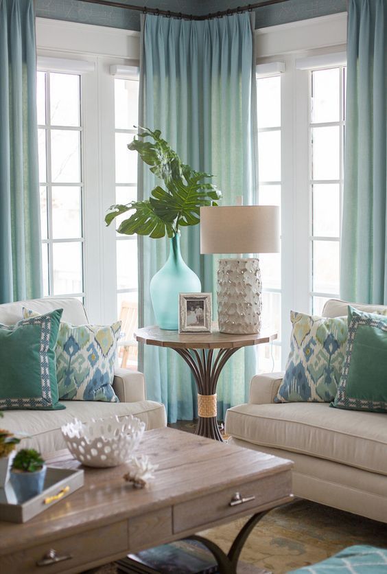 a living room with two couches and a coffee table in front of the window