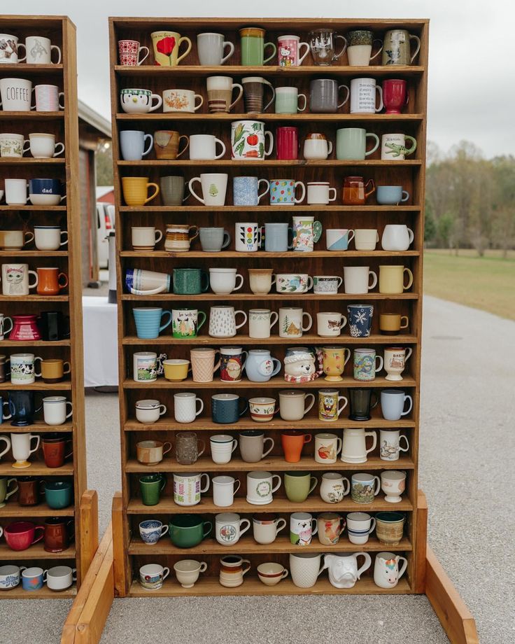 two wooden shelves filled with lots of coffee mugs