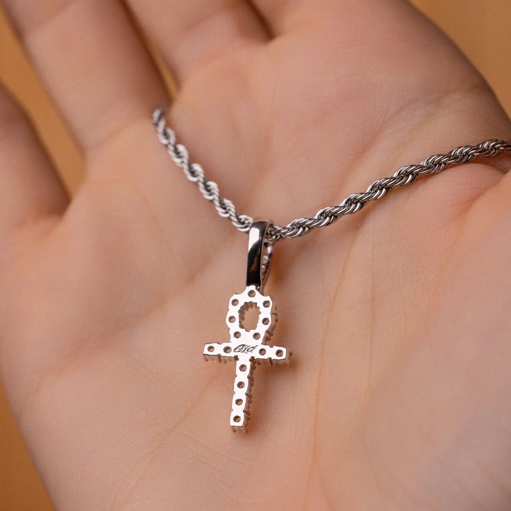 Known as “The Key of the Nile” the Ankh is one of the most sacred Egyptian symbols representing eternal life. We carefully hand-set all stones, executing top craftsmanship. This micro-sized pendant now in white gold is sleek and will accentuate any fit. This product is guaranteed for life - GLD will repair the item should you experience any defects in craftsmanship or breakage. Specifications - 11mm x 19mm (Width x Height) - Bail: Fits up to 4mm Rope Chain - Weight: (Weight can vary +/- 0.5 gram White Gold Cross Jewelry For Spiritual Style, Spiritual White Gold Pendant Jewelry, Spiritual White Gold Cross Jewelry, White Diamond Spiritual Jewelry, Spiritual White Diamond Jewelry, Symbolic White Gold Cross Pendant Jewelry, Symbolic Diamond Jewelry With Gemstones, Spiritual Diamond Round Pendant Jewelry, Symbolic Diamond Pendant Jewelry