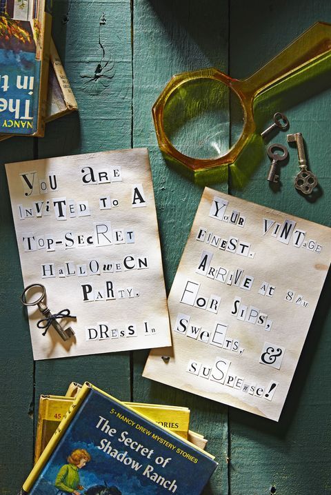 two pieces of paper with writing on them next to books and magnifying glasses