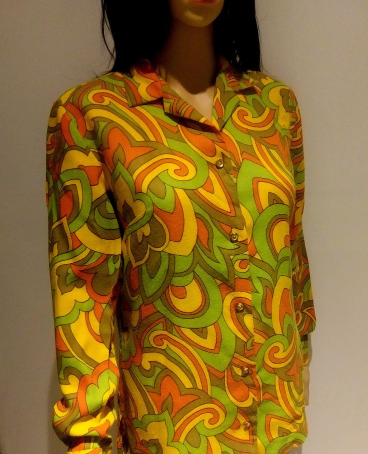 "Vintage 60's, Cos Cob Label -  Mod, darted, blouse in bright,   groovy print !Long Sleeve, 22 inches, with button down front  (5 small, gold tone metal buttons) and vented sides 3 1/2 \" on each side Marked 11/12  - vintage sizing so probably a small Med.  See Measurements below.  Measures:  20 Inches from armpit to armpit.                      Center Back Length: 26 Inches In Excellent condition.  Cos Cob used to be a \"snooty\" brand to buy for me growing up.  The stores are defunct now... I Retro Shirt With Vibrant Spring Print, Green Retro Print Shirt For Spring, Fitted Green Tops With Retro Print, Fitted Green Top With Retro Print, Fitted Retro Print Groovy Top, Fitted Groovy Retro Print Top, Fitted Groovy Top With Retro Print, Retro Yellow Tops With Retro Print, Yellow Retro Tops With Retro Print