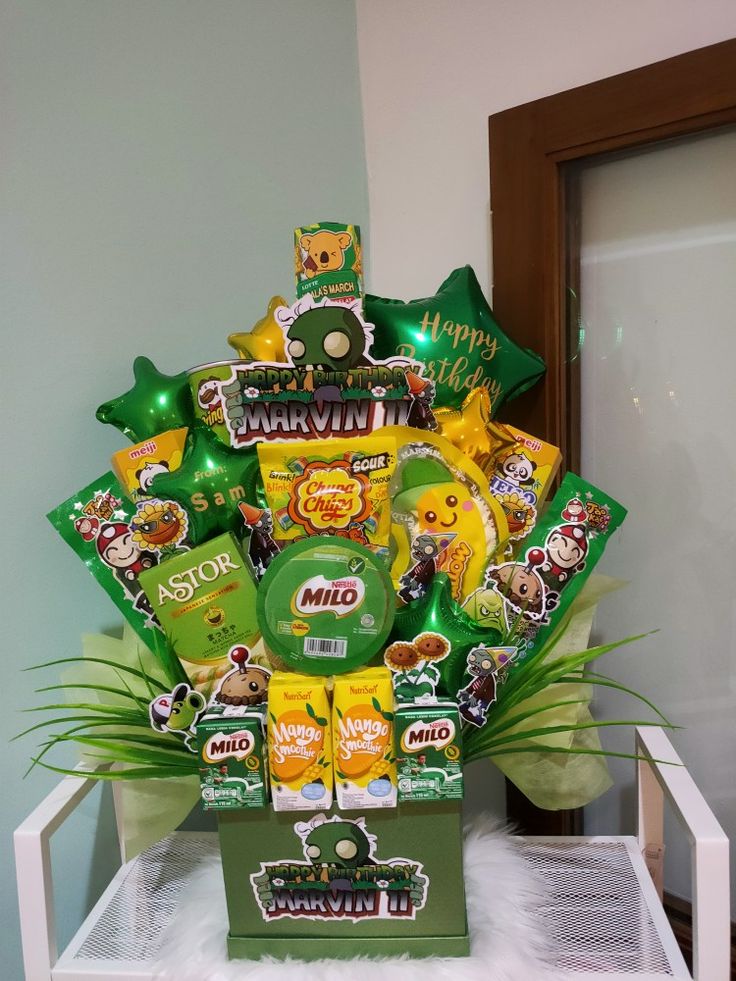 a large green and yellow gift basket filled with candy