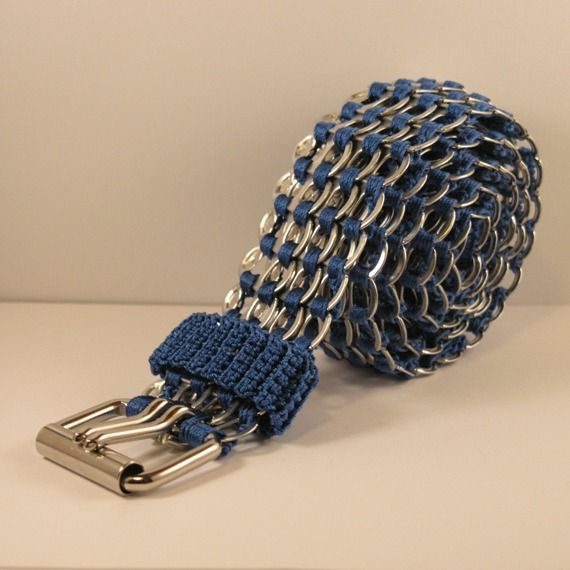 a blue and silver chain belt on a white surface with a metal buckle attached to it