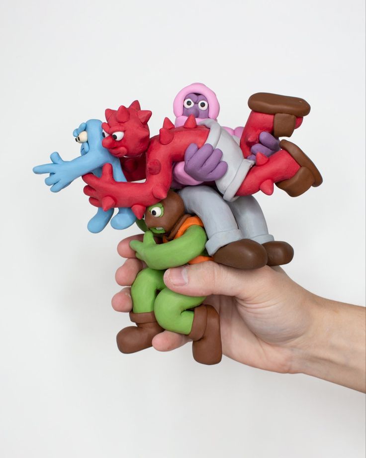 a hand holding a bunch of small toys