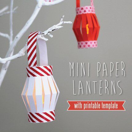 paper lanterns hanging from a tree branch with the words mini paper lanterns written below them