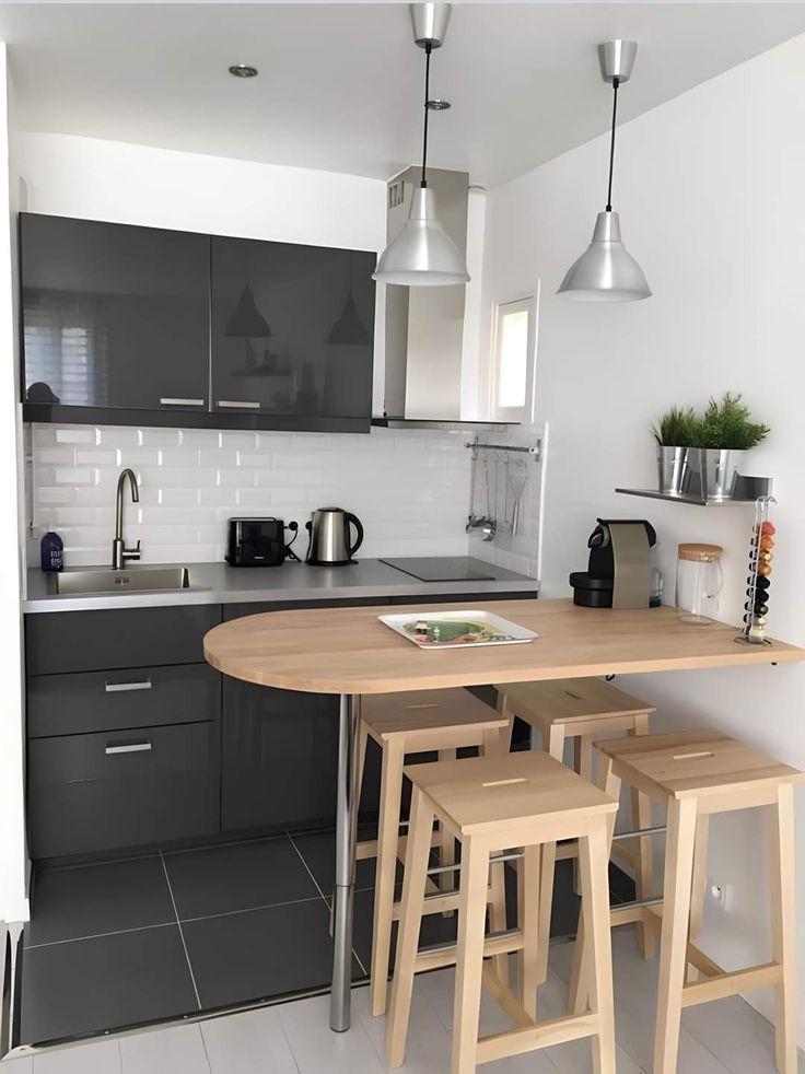 a kitchen with stools and a table in it