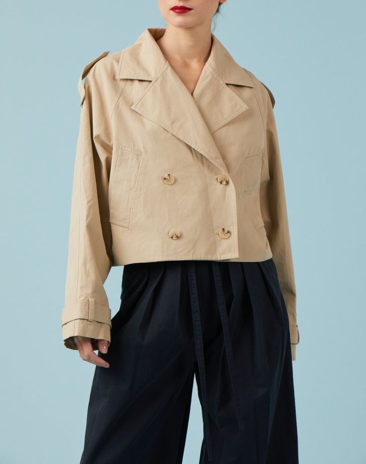 The Sydney Cropped Trench is a cotton twill jacket with all the details of a classic trench coat, but with a cropped fit. Features a notched lapel collar, double breasted closure, and shoulder tab details. The perfect not-too-cropped length make this the perfect and easy piece! Fit + Measurements Length =25" (from shoulder) Measurement taken from size Small Margarita is 5'8 1/2" and is wearing size Small Fits true to size Beige Cotton Double-breasted Outerwear, Spring Gabardine Pea Coat With Double-breasted Button, Spring Cotton Double-breasted Outerwear, Cotton Double-breasted Outerwear For Work, Spring Gabardine Pea Coat With Double-breasted Button Fastening, Double-breasted Cotton Outerwear With Double Button Closure, Cotton Double-breasted Outerwear With Lapel Collar, Chic Cotton Outerwear With Double Button Closure, Cropped Cotton Workwear Jacket