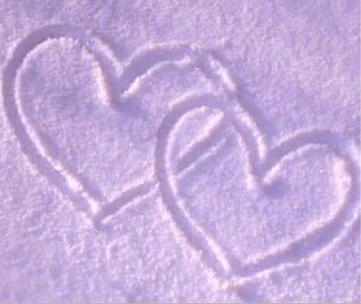 two hearts drawn in the snow next to each other