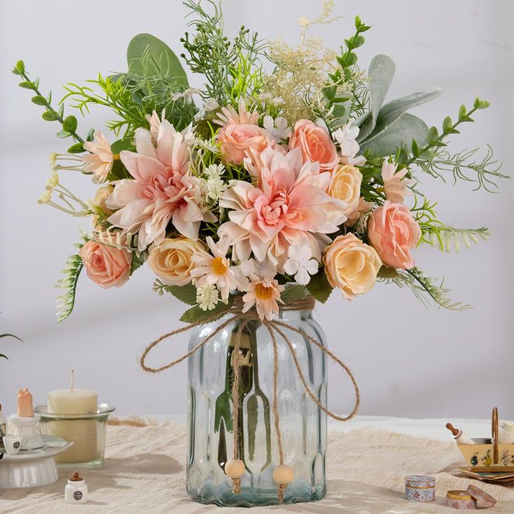 a vase filled with lots of flowers on top of a table