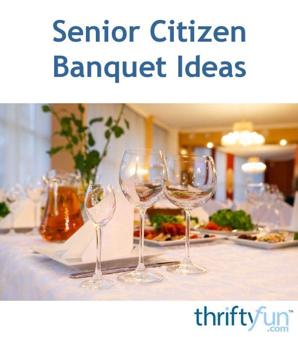 a table topped with wine glasses and plates filled with food on top of a white table cloth