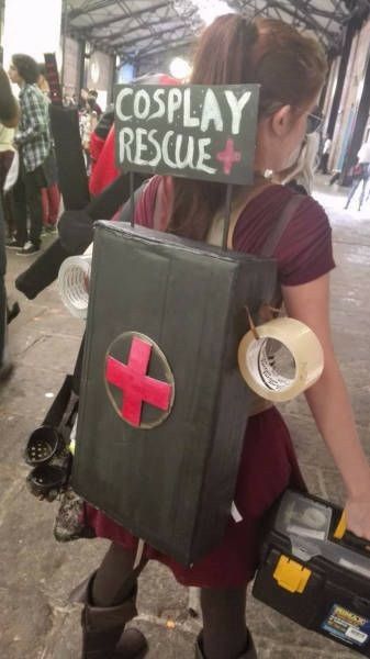 a woman in costume holding a box with a sign on it that says cosplay rescue