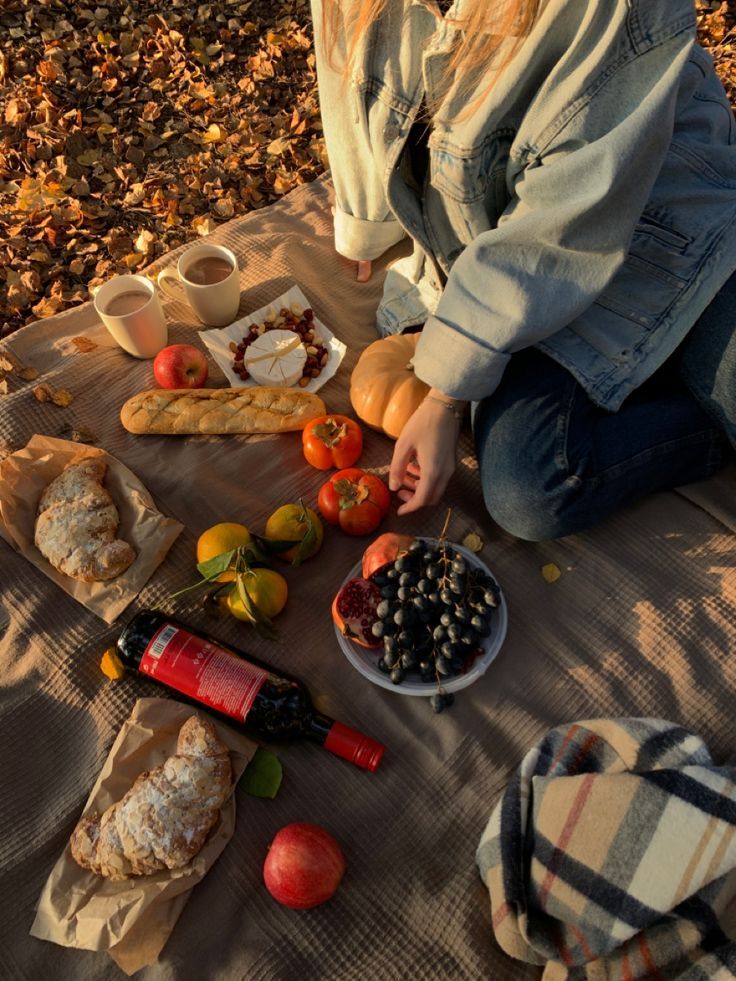 a woman is sitting on the ground with food