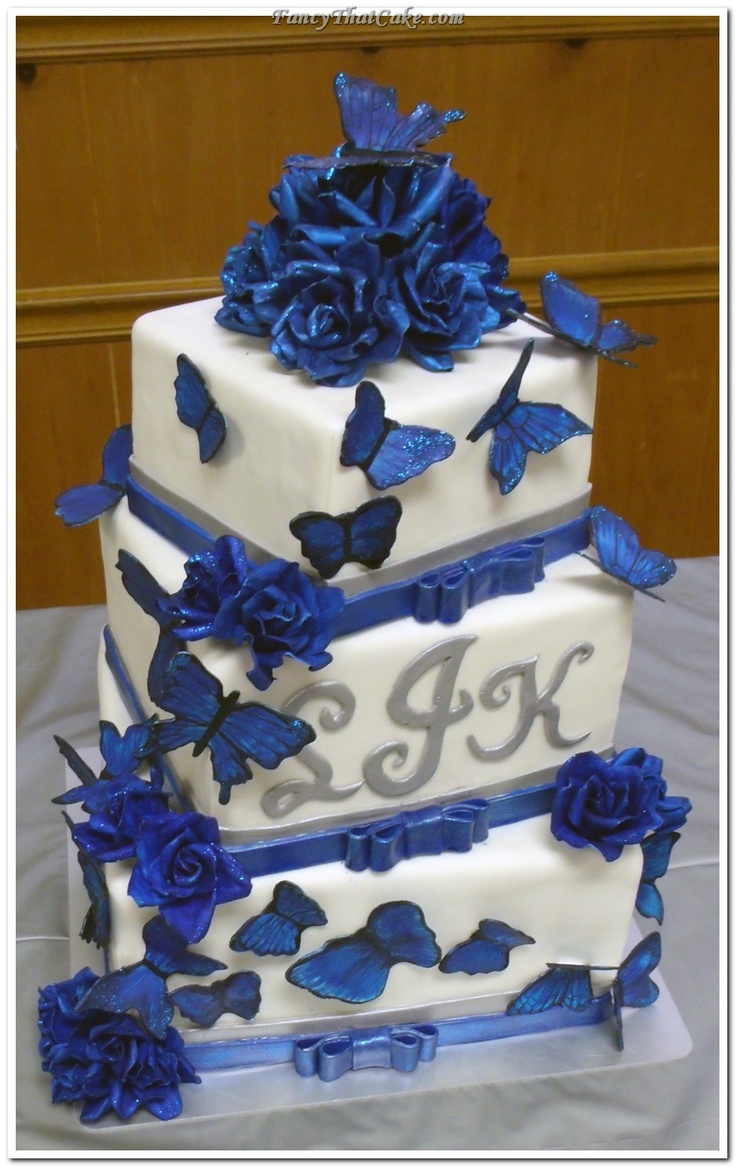 a three tiered cake with blue butterflies on it