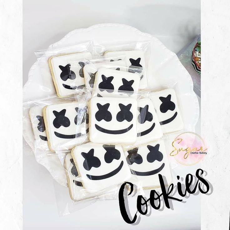 cookies decorated with black and white designs on a plate that says, cookie's