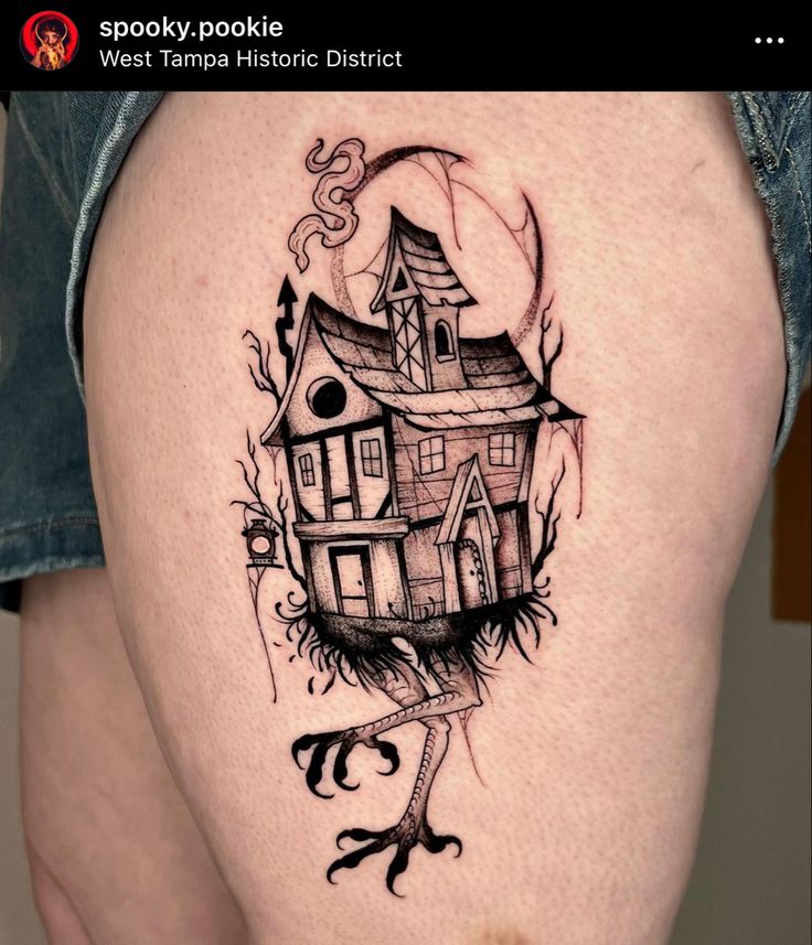 a woman's thigh with a house tattoo on it