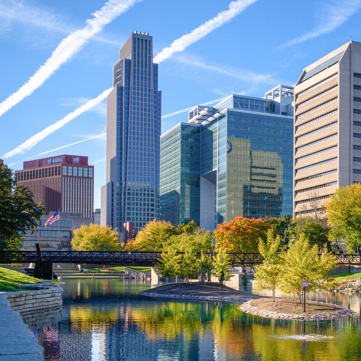 there are many tall buildings in the city and one is across the river from it