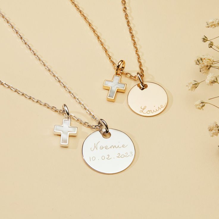 The perfect personalized necklace to celebrate a christening or communion. Cherish special memories with our Personalized Mother of Pearl Cross Necklace. Hand-engrave precious dates or names onto the front and reverse of your preferred disc and pair with an elegant mother-of-pearl cross charm. 18K Champagne Gold Plated or 925 Sterling SilverSmall Flat Disc: 0.6 x 0.6Medium Flat Disc:  0.7 x 0.7Mother of Pearl Cross: 0.4 x 0.3Charms are removable from this chain and can be worn on all Merci Maman Wedding Cross Pendant Necklace With Engraving, Wedding Engraved Cross Pendant Necklace, Personalized White Gold Cross Pendant Necklace, Engraved Cross Pendant Necklace For Wedding, Personalized Engraved Cross Necklace, Personalized Yellow Gold Necklaces For First Communion, Personalized Yellow Gold Necklace For First Communion, Personalized Necklace For First Communion And Mother's Day, Personalized Necklaces For First Communion And Mother's Day