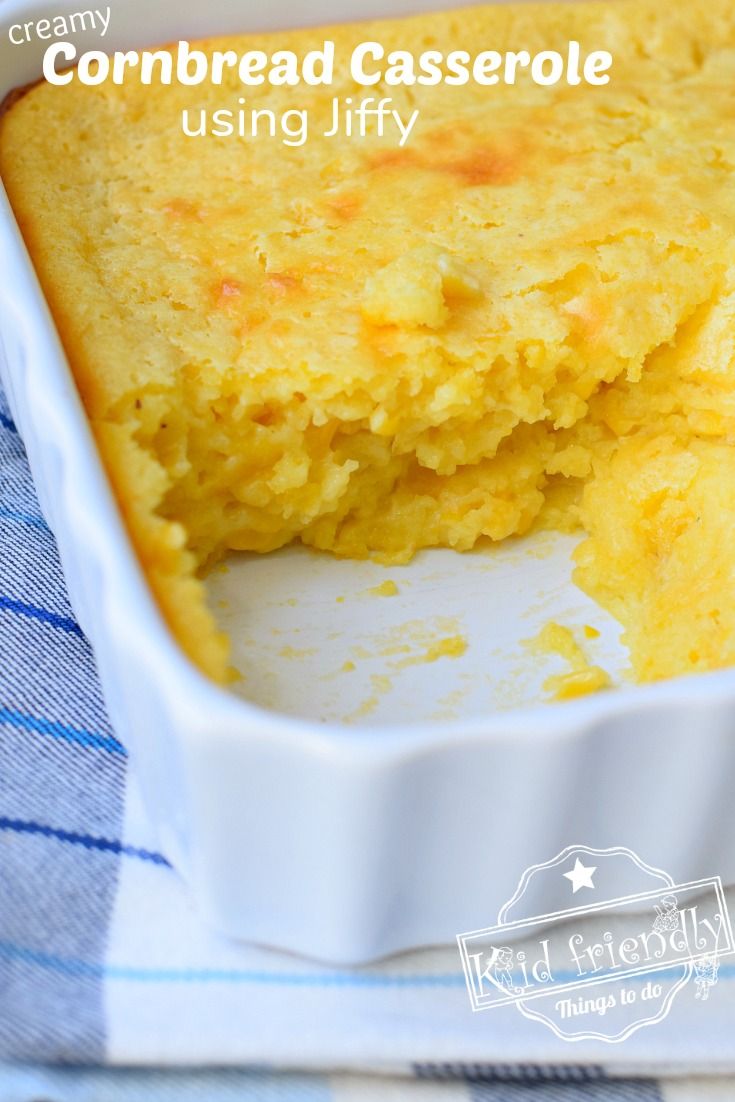 cornbread casserole in a white dish on a blue and white towel