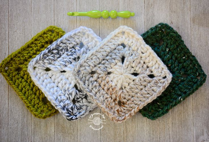 four crocheted squares are sitting next to each other