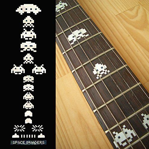 an image of a guitar with pixel art on the fret cover and inlays