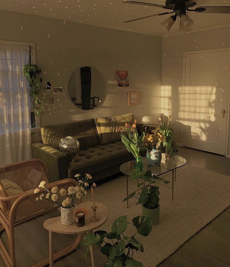 a living room filled with furniture and plants