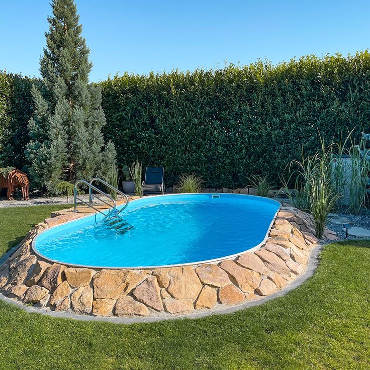 a backyard with a pool surrounded by grass