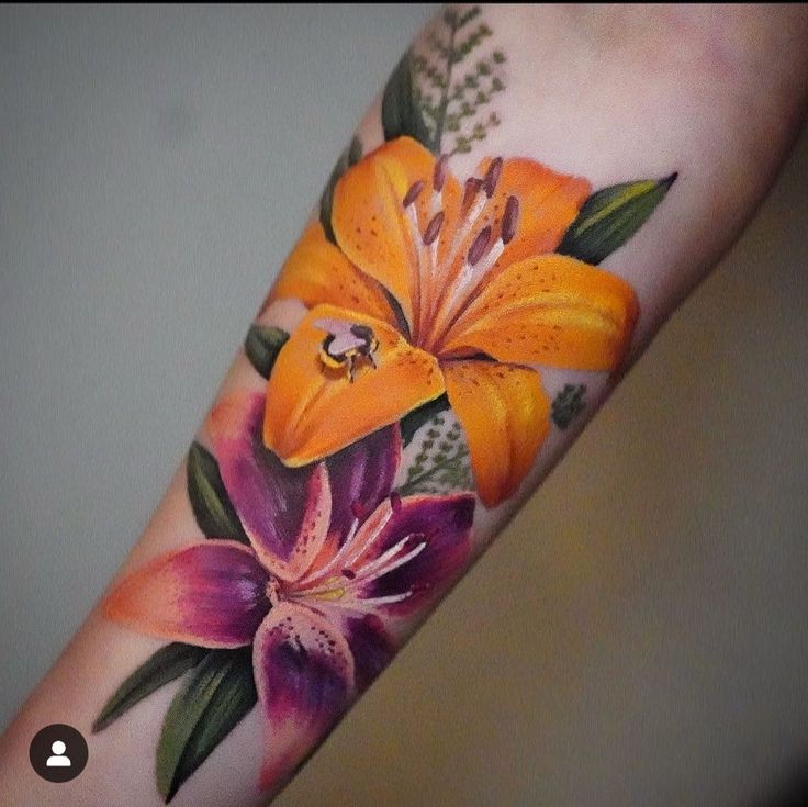 an orange lily tattoo on the arm