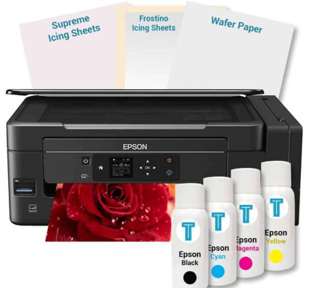 the epson printer is next to four ink cartridges and two sheets of paper that have been placed on top of it