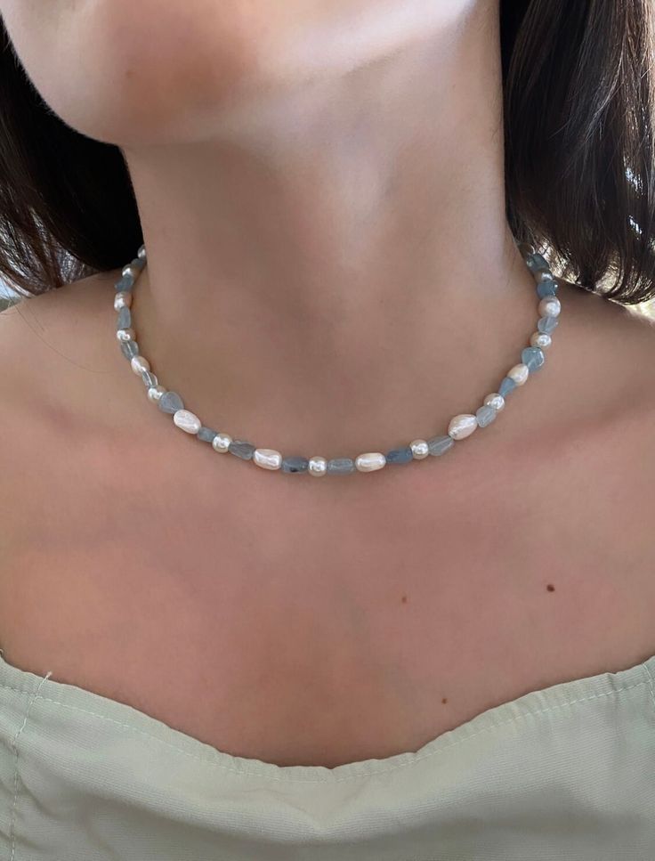 ♥Who needs a tropical vacation when you can wear it on your neck? The Bora Bora necklace is the must-have summer staple that alternates between real freshwater pearls and aquamarine crystals.  ♥MATERIAL - The pearls are real freshwater pearls and the stones are genuine aquamarine. ♥NECKLACE LENGTH: 14 inches - We add a 2in extender chain at the end to make the necklace adjustable (14 inches - 16 inches or 16 inches - 18 inches) - If you would like a different length, feel free to send me a message! ♥CARE TIPS - Avoid contact with perfumes, body oils, and other chemicals, including household cleaners - Never use chemical jewelry cleaners as these will do more harm than good. - For light cleaning, gently polish with a soft, lint-free cloth to avoid scratching. - Store it in a cool dry place. Blue Necklace Aesthetic, Oval Stud Earrings, Necklace Birthstone, Aquamarine Necklace, Aquamarine Crystal, Summer Necklace, Necklace Beaded, Necklace Blue, Blue Jewelry