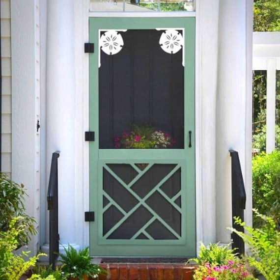 a green front door on a white house