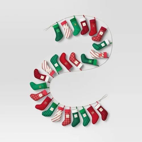 christmas stockings hanging on a clothesline with the letter s in it's center