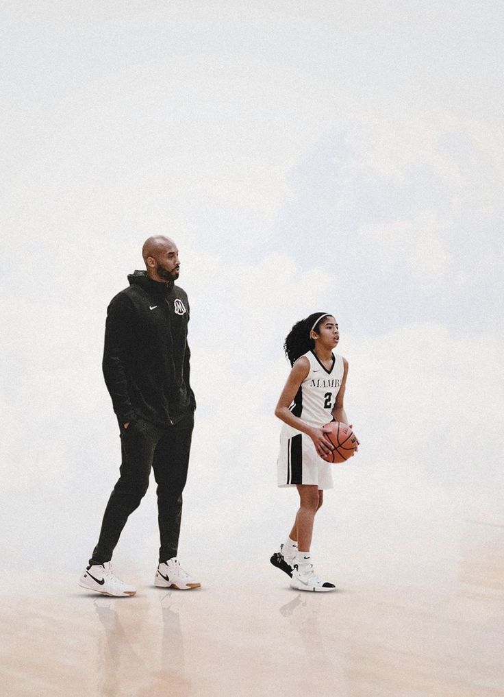 a man standing next to a woman holding a basketball