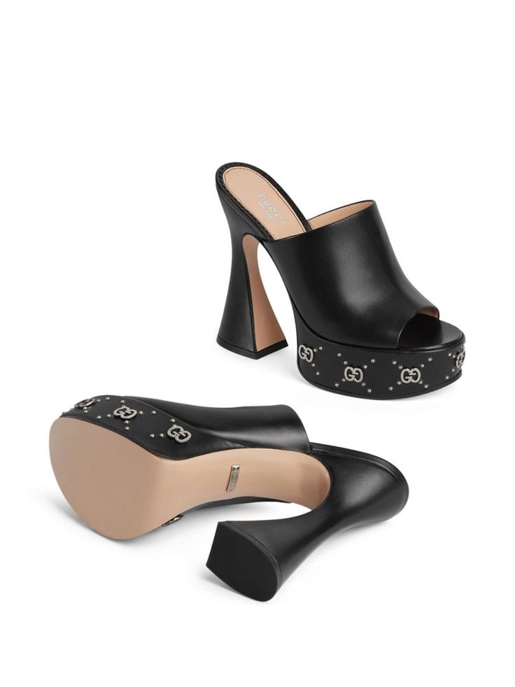 GG 115mm platform mules from Gucci featuring black, leather, silver-tone stud detailing, open toe, slip-on style, branded insole, platform sole and high block heel. This item is in size 36 and the color is Black Gucci Luxury Round Toe Slides, Gucci Luxury Open Heel Mules, Gucci Calf Leather Sandals, Luxury Gucci Open Heel Mules, Luxury Gucci Heels With Removable Insole, Luxury Gucci Heels With Square Toe, Classic Luxury Gucci Heels, Gucci Sandals With Woven Sole, Gucci Luxury Heels With Sculpted Heel