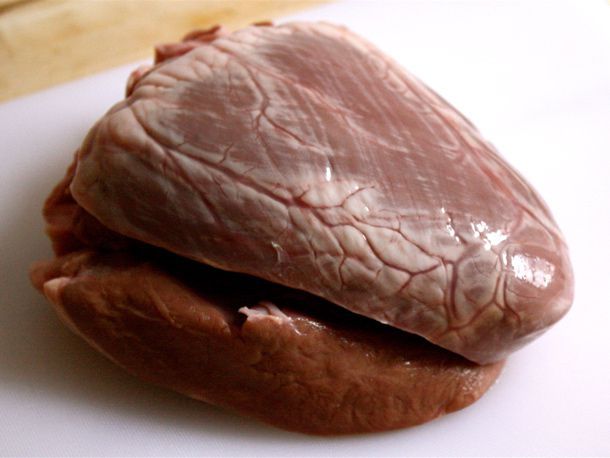 a piece of meat sitting on top of a white cutting board